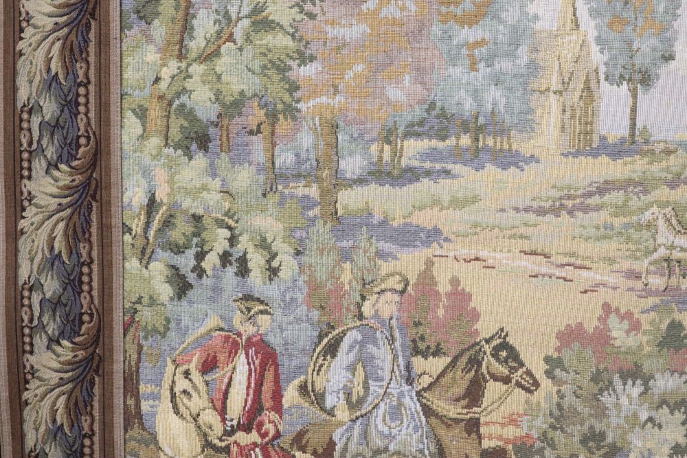 An Aubusson style machine woven hanging tapestry depicting a hunting party, with pole